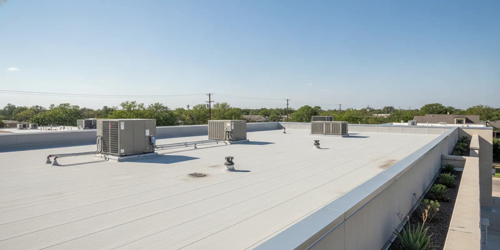 Commercial flat roof with rooftop equipment and visible drainage details
